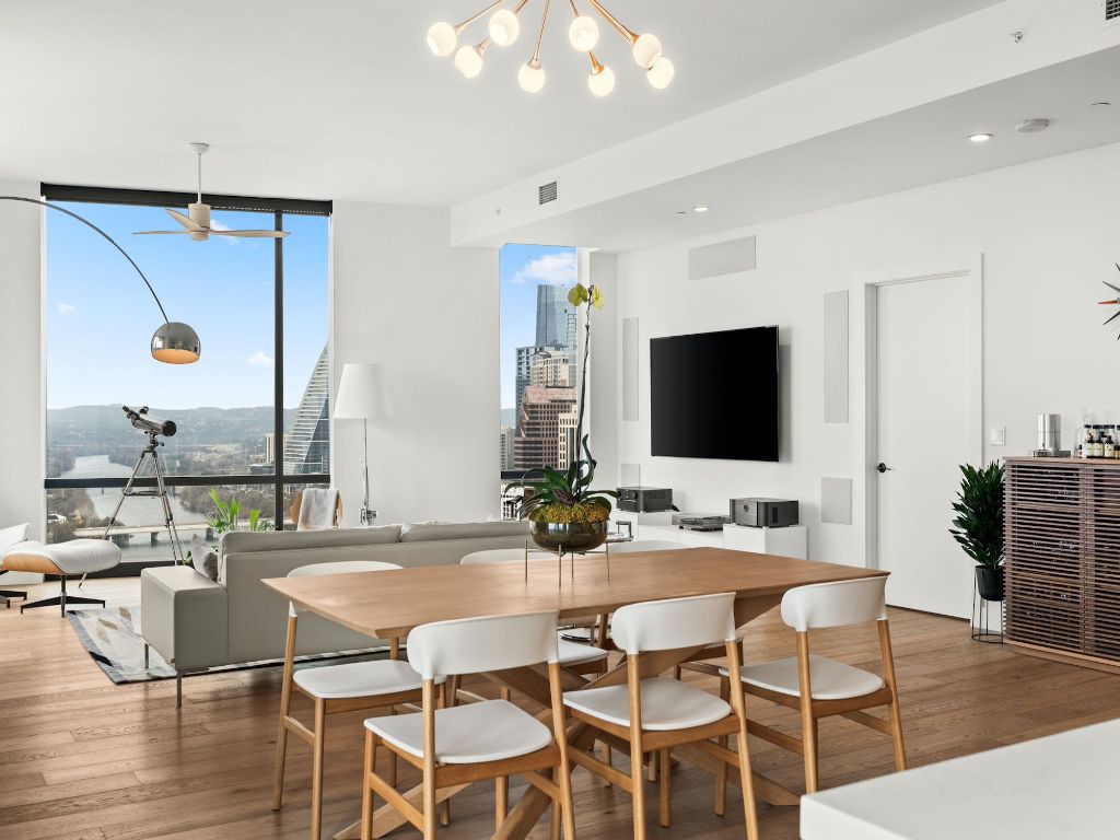 70 Rainey Street, Unit 2301 Austin, TX 78701 - Photo 14 of 40 a dining room with furniture and wooden floor