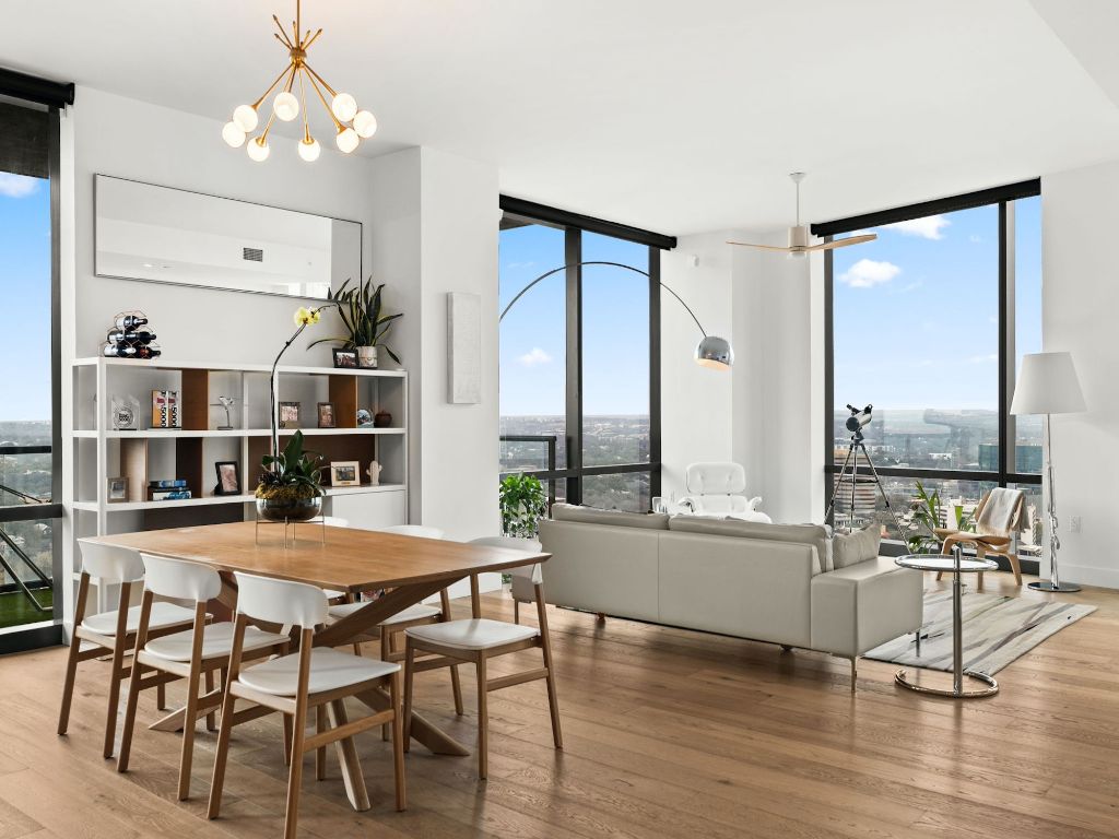 70 Rainey Street, Unit 2301 Austin, TX 78701 - Photo 15 of 40 a dining room with furniture window and wooden floor