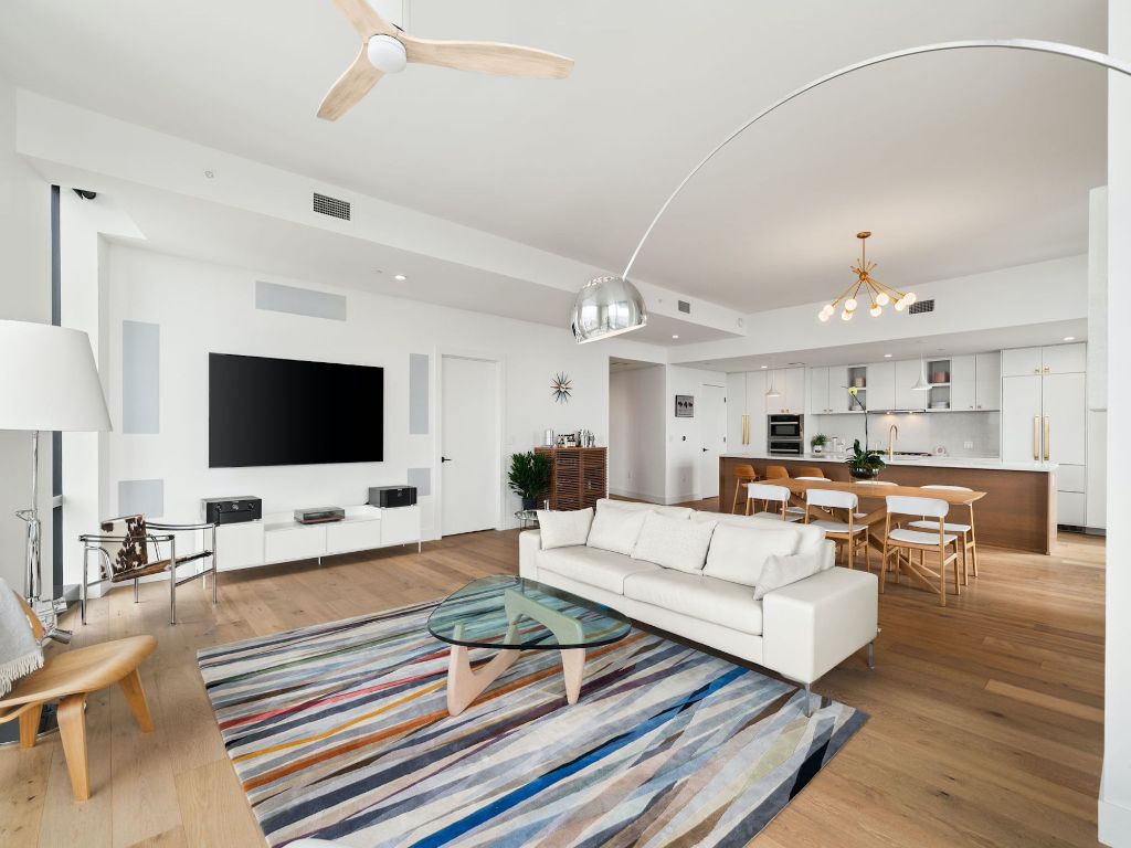 70 Rainey Street, Unit 2301 Austin, TX 78701 - Photo 2 of 40 a living room with furniture kitchen view and a flat screen tv