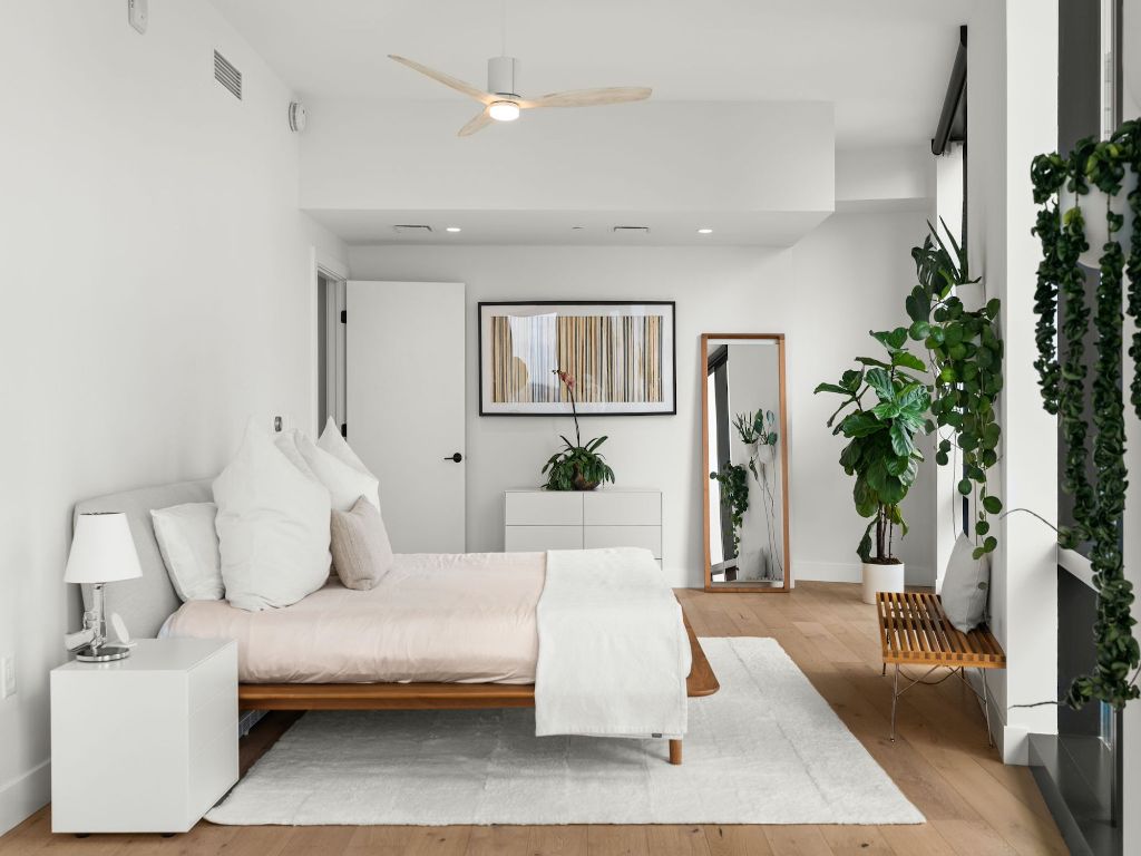 70 Rainey Street, Unit 2301 Austin, TX 78701 - Photo 22 of 40 a spacious bedroom with a large bed and a couch