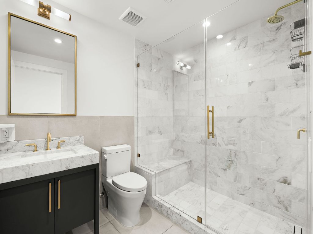 70 Rainey Street, Unit 2301 Austin, TX 78701 - Photo 29 of 40 a bathroom with a sink a toilet and shower