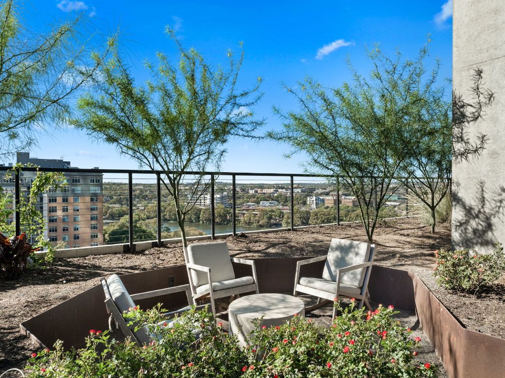 70 Rainey Street, Unit 2301 Austin, TX 78701 - Photo 37 of 40 a view of a patio with couches table and chairs potted plants and large tree