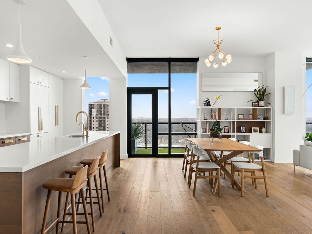 70 Rainey Street, Unit 2301 Austin, TX 78701 - Photo 10 of 40 a view of a dining room with furniture and wooden floor