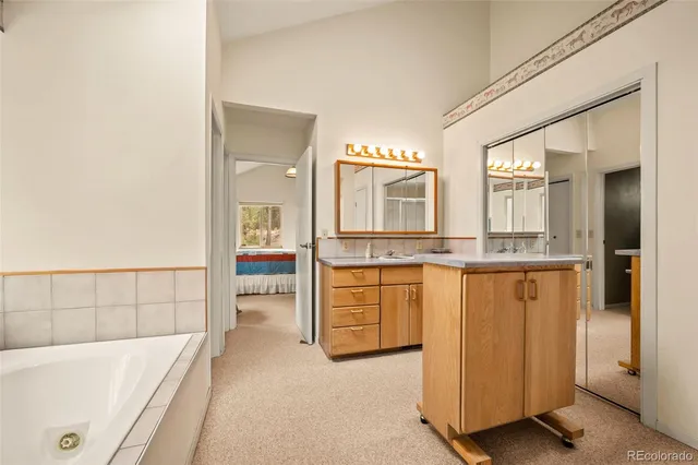 a bathroom with a granite countertop sink and mirror