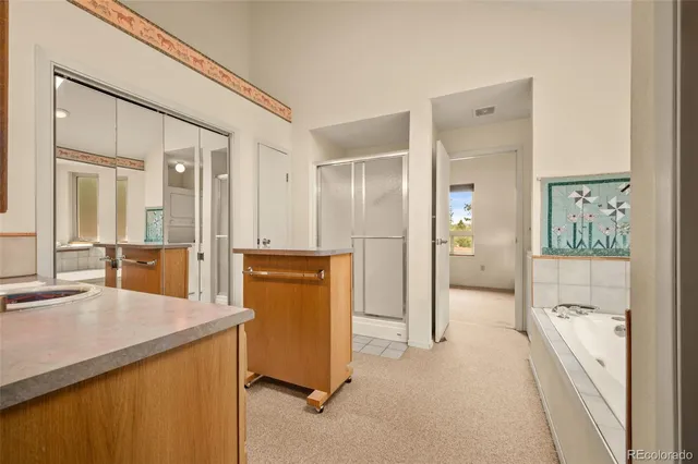 a spacious bathroom with a shower and a sink