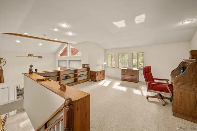 a living room with furniture a flat screen tv and a table