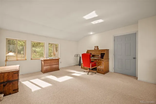 a view of a room with furniture and windows