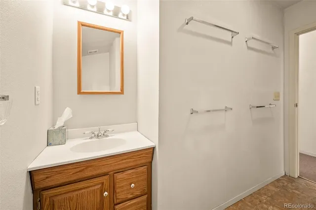 a bathroom with a sink a vanity and a mirror