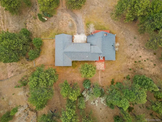 an aerial view of a house with a yard