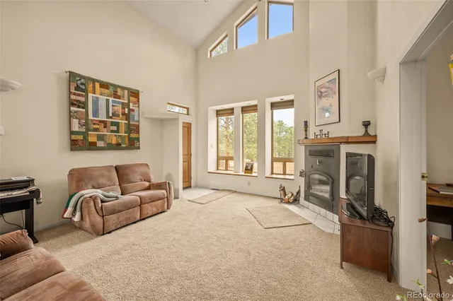 a spacious bedroom with furniture and a fireplace