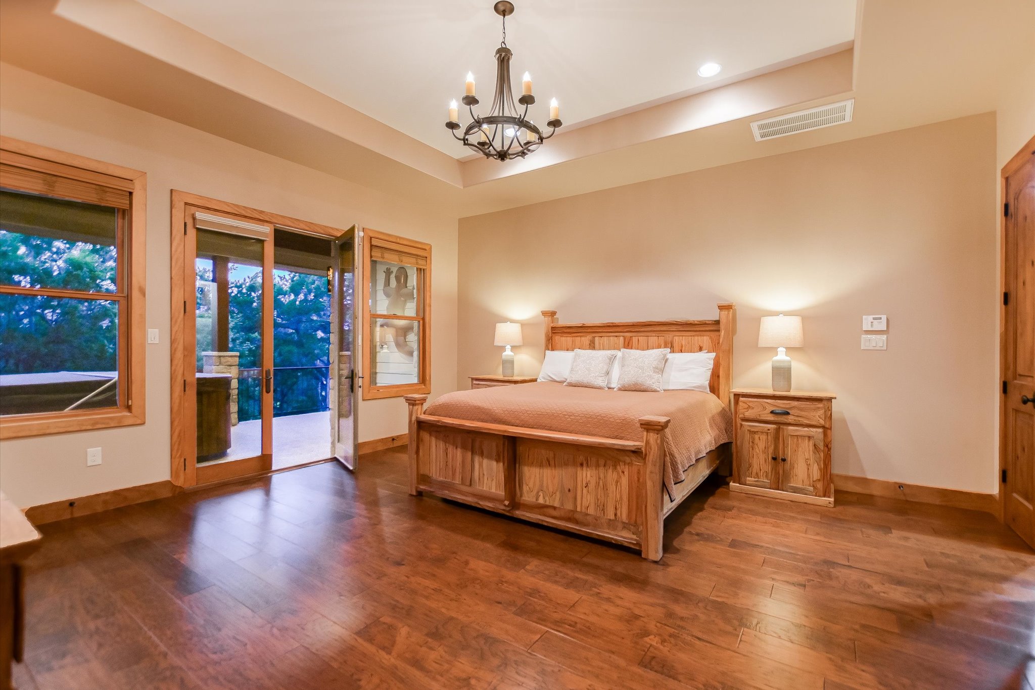 409 Venture Boulevard South Point Venture, TX 78645 - Photo 13 of 37 Spacious room featuring wood-finish flooring, a tray ceiling with a chandelier, and recessed lighting