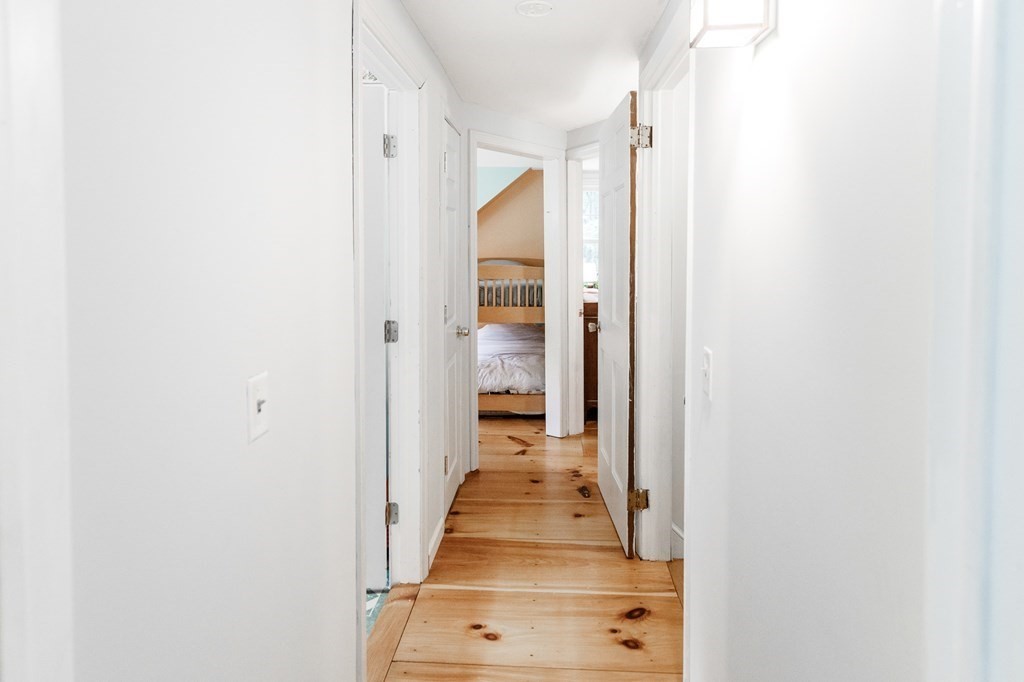 301 Main Road Montgomery, MA 01085 - Photo 20 of 41 a view of a hallway with wooden floor and staircase