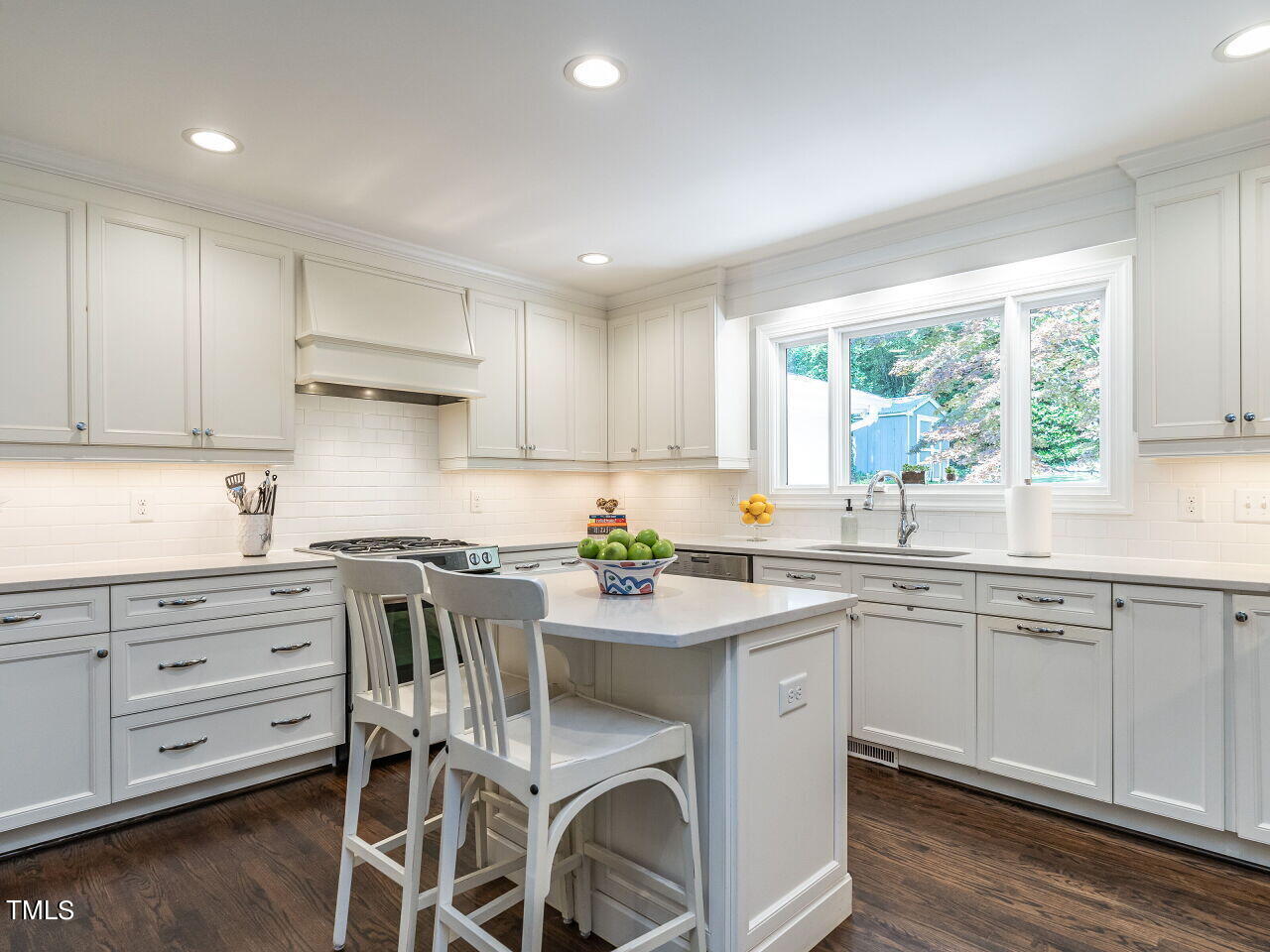 900 Davidson Street Raleigh, NC 27609 - Photo 11 of 36 a kitchen with a sink white cabinets and wooden floors
