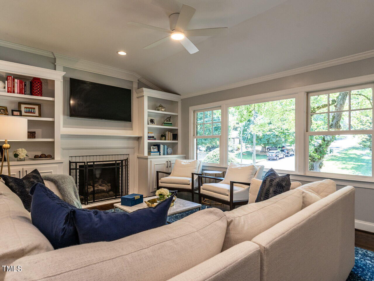 900 Davidson Street Raleigh, NC 27609 - Photo 5 of 36 a living room with furniture a flat screen tv and a fireplace