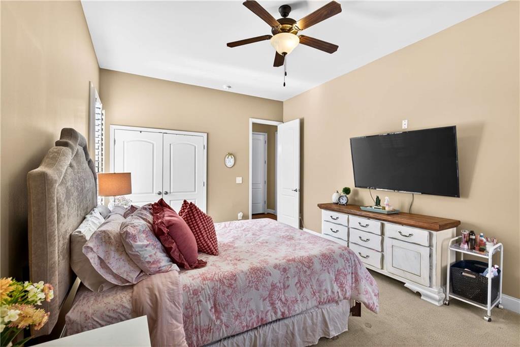 340 Scott Farm Drive Powder Springs, GA 30127 - Photo 23 of 59 a bedroom with a bed and a flat screen tv