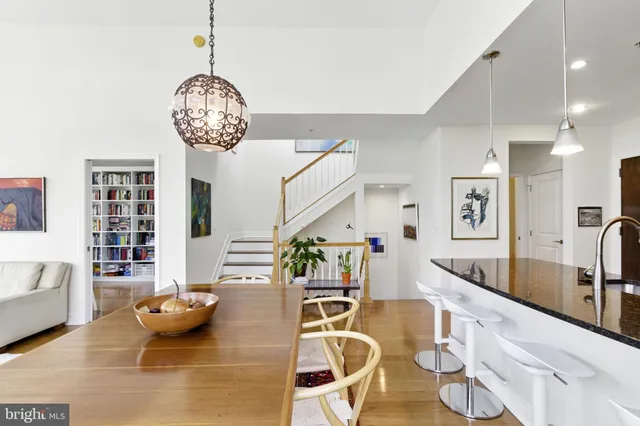 a view of a dining room with furniture a chandelier and wooden floor