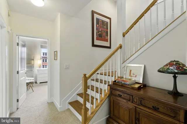 a view of entryway and hall with wooden floor