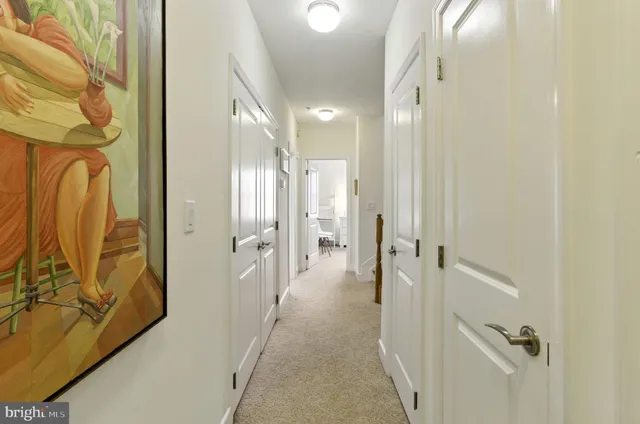 a view of a hallway with wooden floor and closet