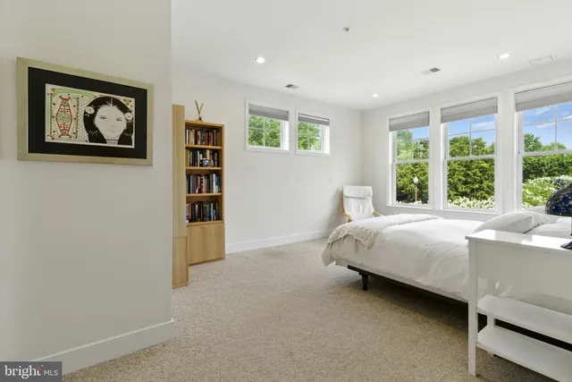 a bedroom with a bed and a large window