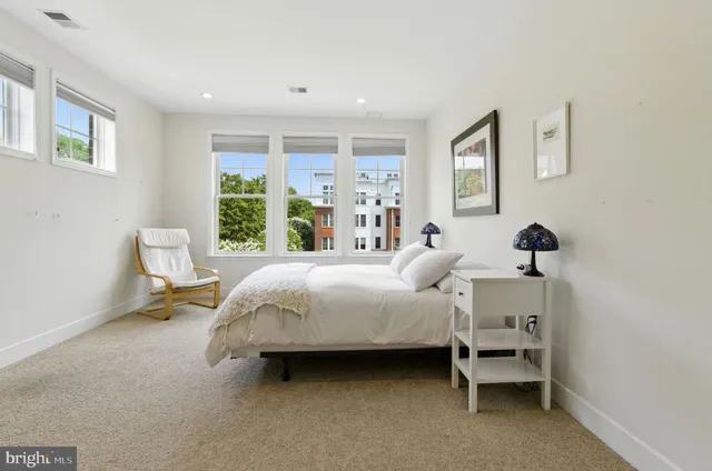 a spacious bedroom with a bed and a window