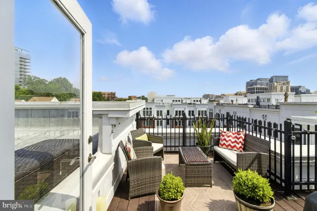 a balcony with an outdoor seating
