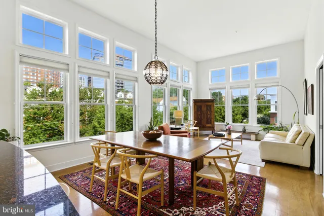 a view of a dining room with furniture large windows and wooden floor