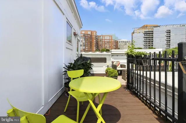 a balcony with table and chairs
