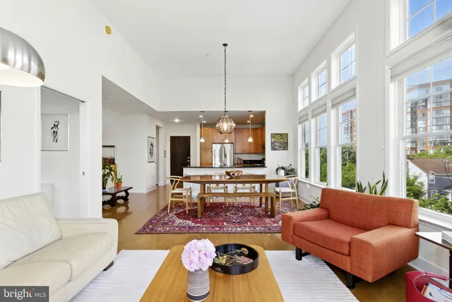 a living room with furniture a rug and a chandelier
