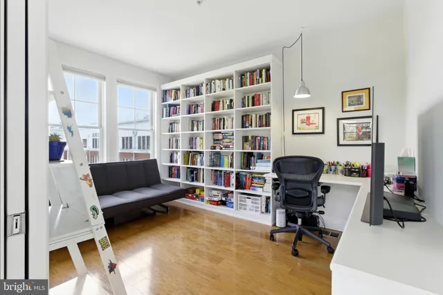 a view of a livingroom with workspace and a couch