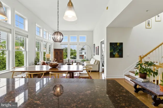 a living room with fireplace furniture and a large window