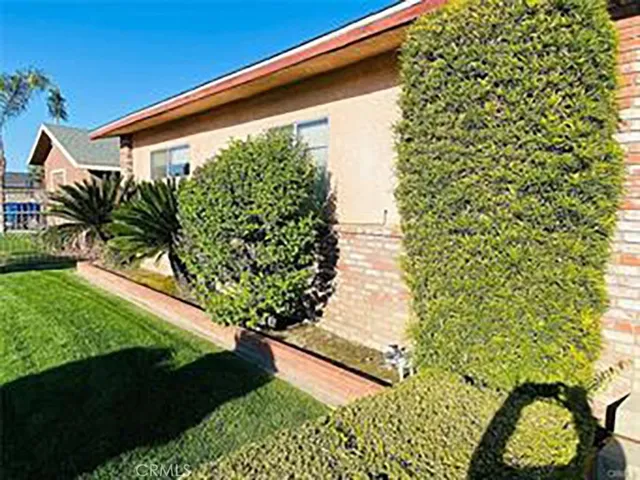 a view of a swimming pool with a garden and deck