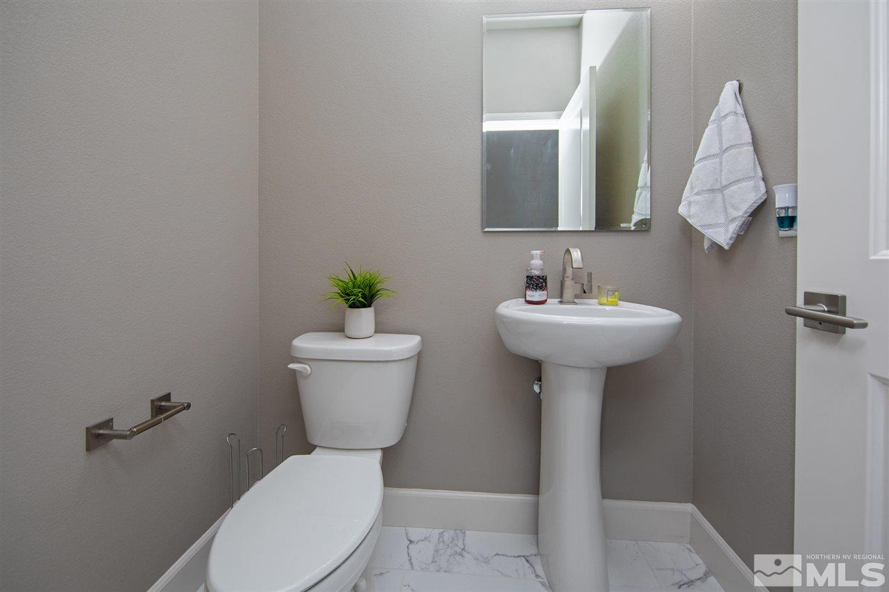601 Riverbed Circle Reno, NV 89521 - Photo 11 of 31 a bathroom with a toilet sink and mirror