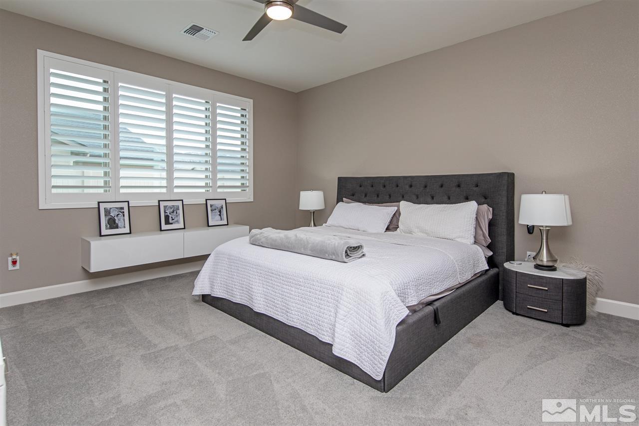601 Riverbed Circle Reno, NV 89521 - Photo 14 of 31 a bedroom with a bed and a large window