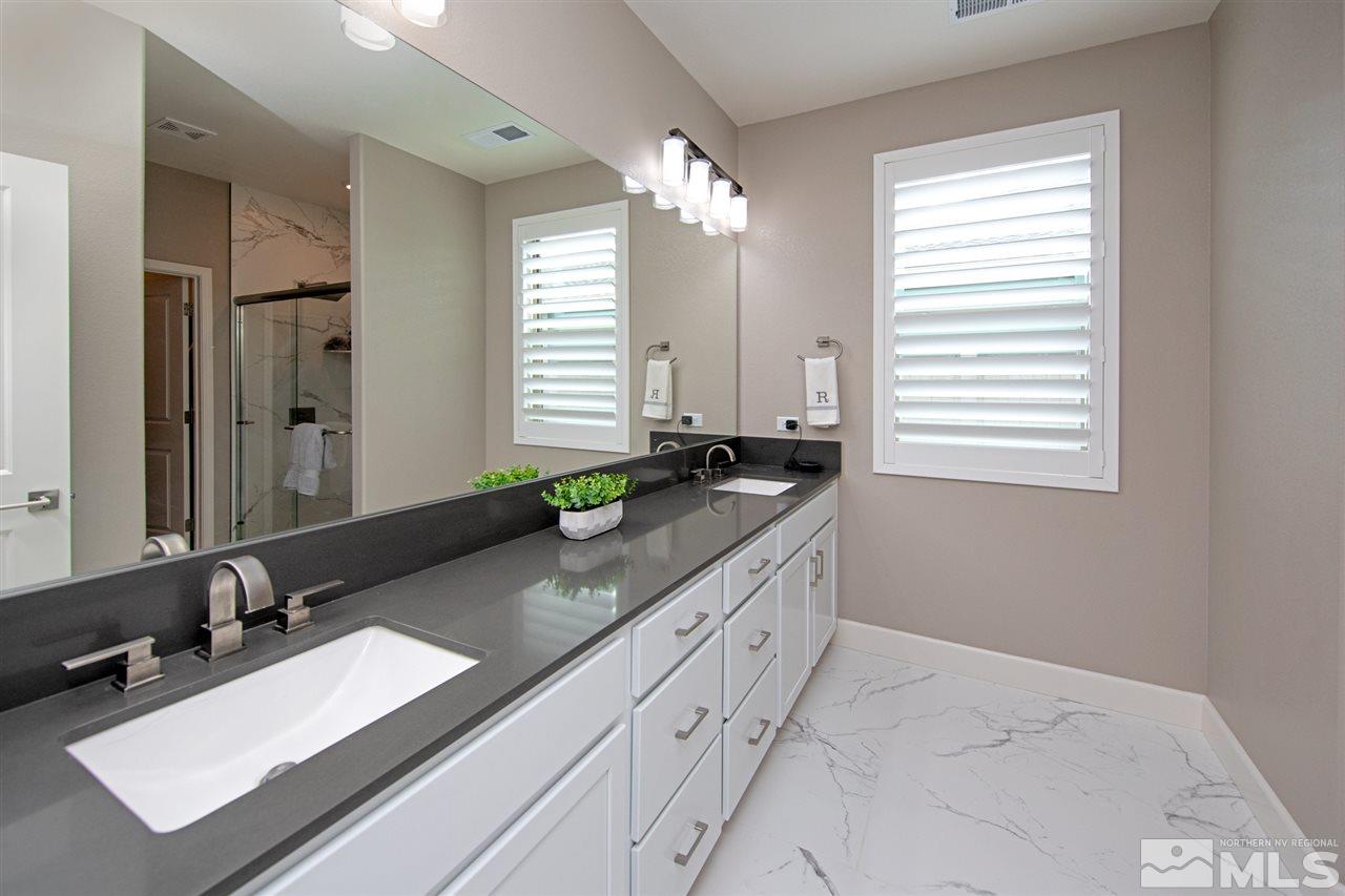 601 Riverbed Circle Reno, NV 89521 - Photo 15 of 31 a bathroom with double sink and a mirror