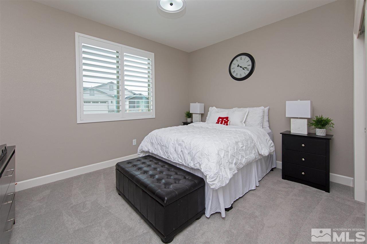 601 Riverbed Circle Reno, NV 89521 - Photo 17 of 31 a bedroom with a bed and a table