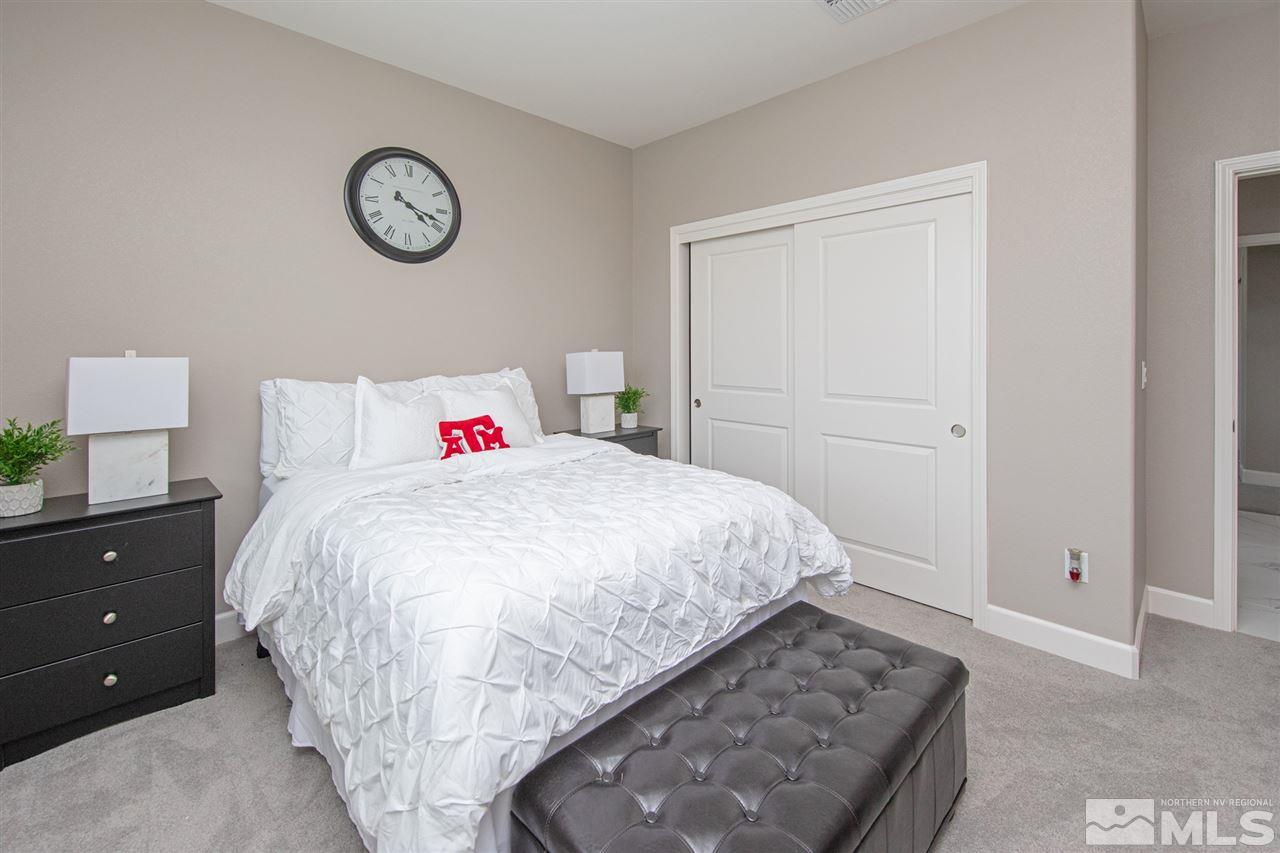 601 Riverbed Circle Reno, NV 89521 - Photo 18 of 31 a bed room with a bed and a table