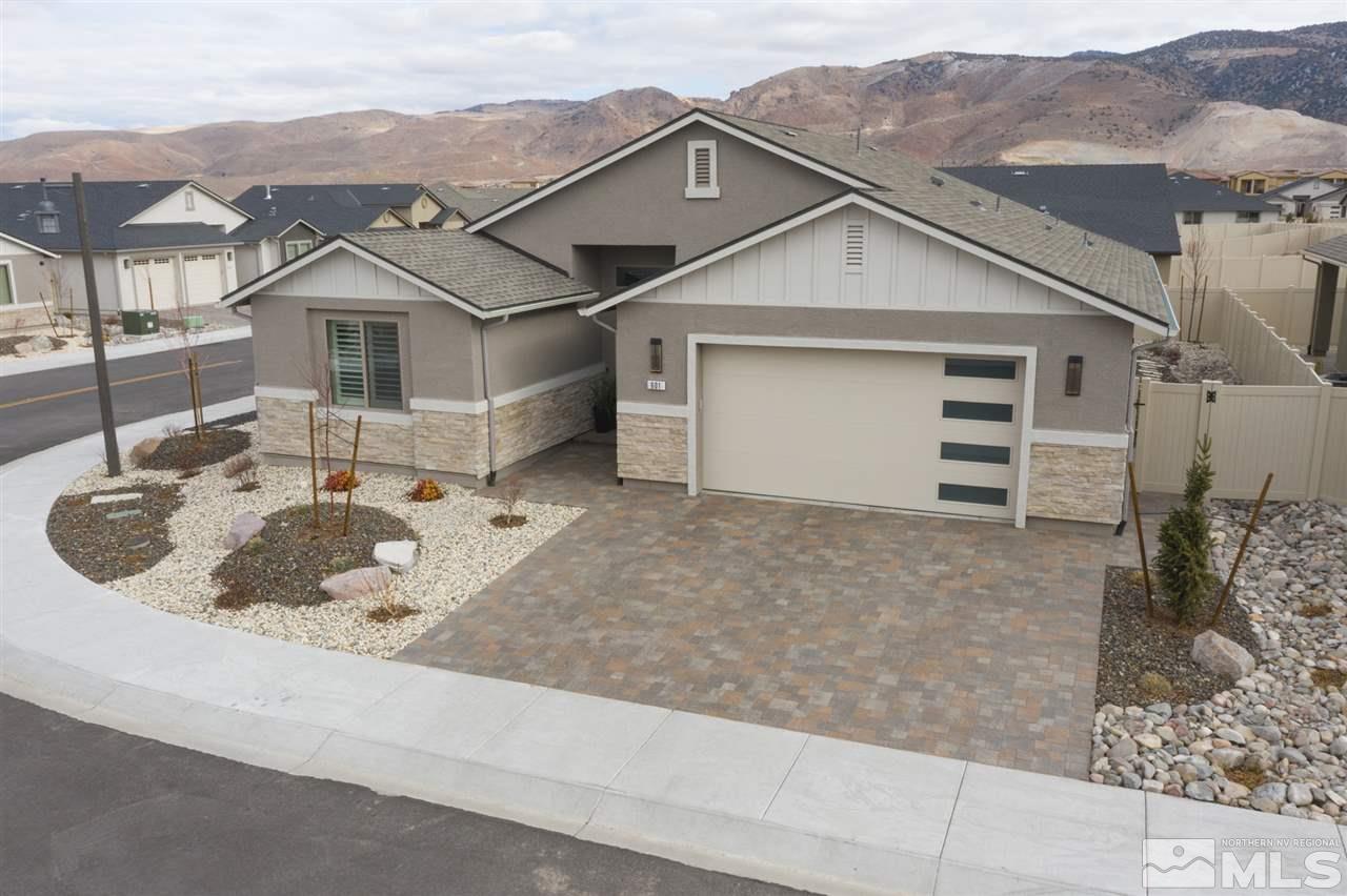 601 Riverbed Circle Reno, NV 89521 - Photo 30 of 31 a white building with a large window and large tree
