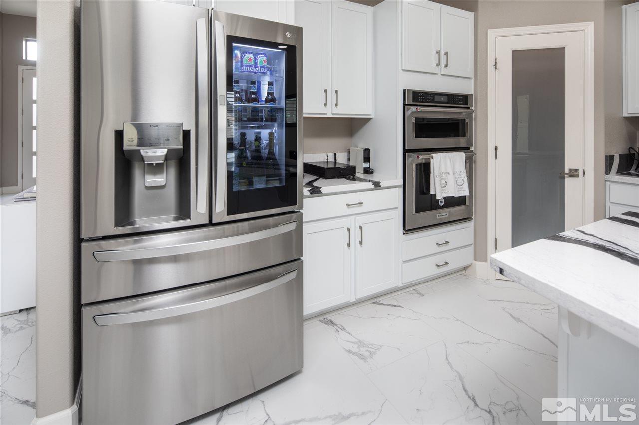 601 Riverbed Circle Reno, NV 89521 - Photo 6 of 31 a kitchen with stainless steel appliances a refrigerator and cabinets