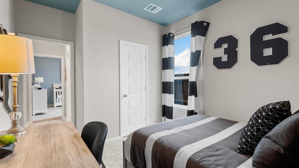 3053 Maple Orch Lane Fort Worth, TX 76140 - Photo 27 of 38 a bedroom with bed and cabinets