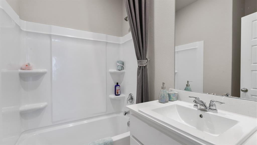 3053 Maple Orch Lane Fort Worth, TX 76140 - Photo 28 of 38 a bathroom with a sink a toilet and shower