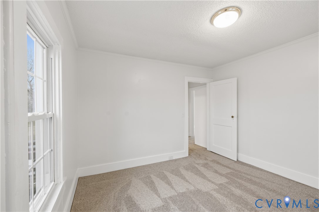 239 Brunswick Road Emporia, VA 23847 - Photo 12 of 24 Crisp white walls, neutral carpeting, and a flush-
