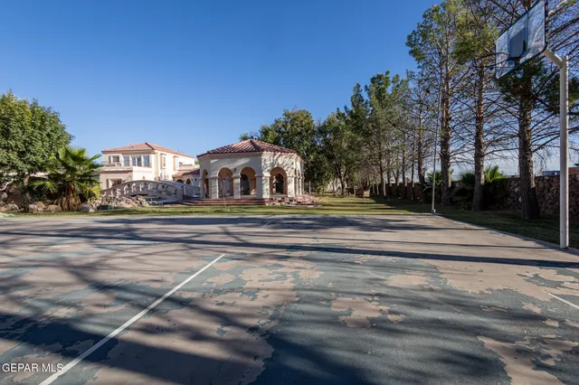 a view of a bedroom with windows and chandelier