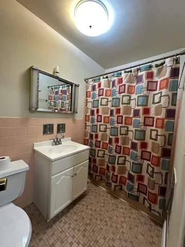 a view of bathroom with a sink toilet and shower