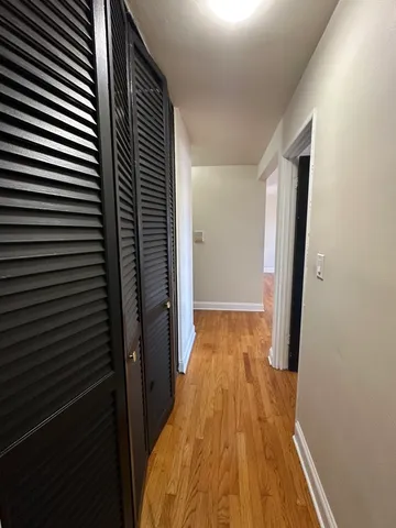 a view of a room with wooden floor