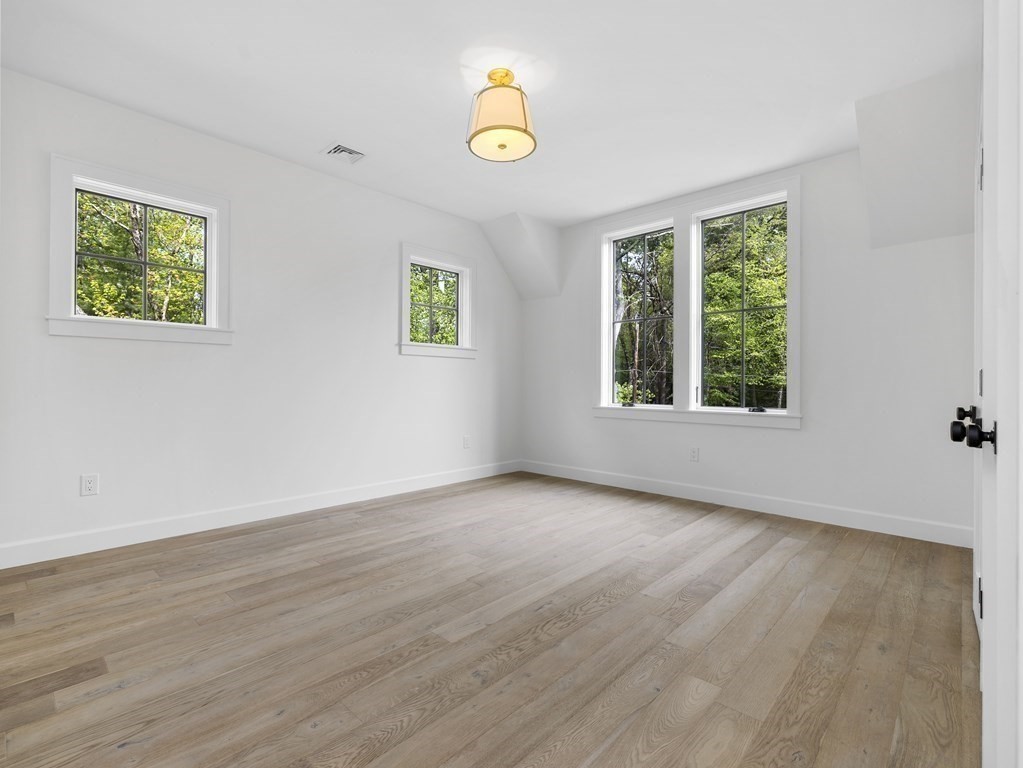 23 Alpine Road Wayland, MA 01778 - Photo 12 of 25 a view of an empty room with window and wooden floor