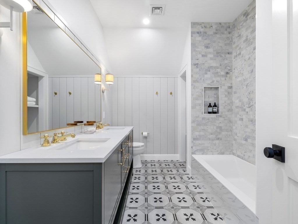 23 Alpine Road Wayland, MA 01778 - Photo 15 of 25 a bathroom with a sink a mirror and a bathtub