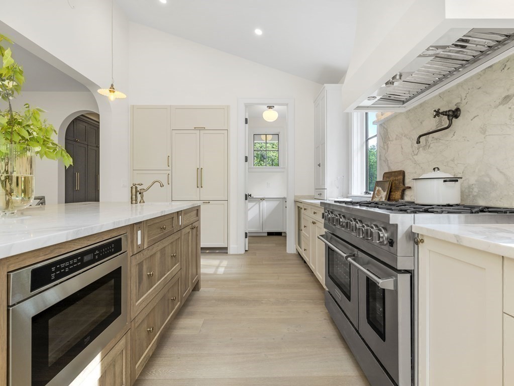 23 Alpine Road Wayland, MA 01778 - Photo 20 of 25 a large kitchen with stainless steel appliances granite countertop a stove and a sink