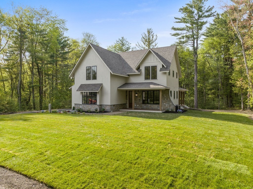 23 Alpine Road Wayland, MA 01778 - Photo 24 of 25 a front view of house with yard and trees in the background