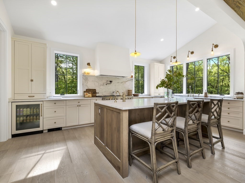 23 Alpine Road Wayland, MA 01778 - Photo 4 of 25 a kitchen with a dining table chairs sink and cabinets