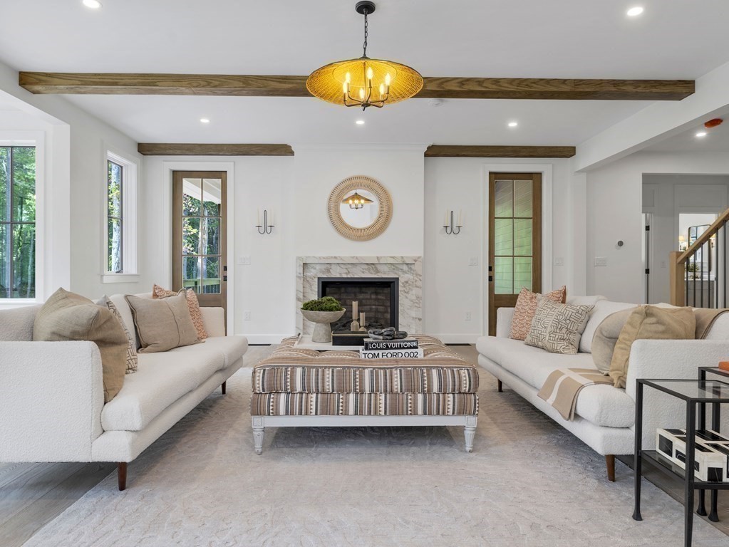 23 Alpine Road Wayland, MA 01778 - Photo 5 of 25 a living room with furniture a fireplace and a large window